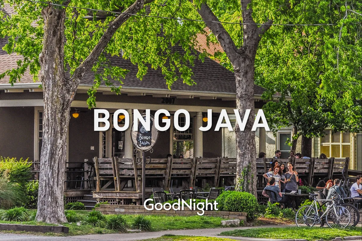 The upbeat exterior of Bongo Java, one of Nashville’s beloved coffee shops, with its signature sign, shaded patio seating, and groups of people socializing or relaxing outdoors. Bicycles and sunny weather add to the inviting, local vibe.