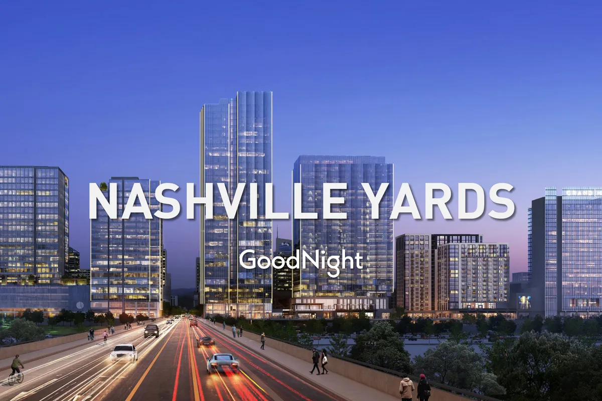 A vibrant cityscape at dusk, featuring modern skyscrapers, glowing city lights, and a busy road. The scene evokes Nashville's energetic urban vibe and business-friendly atmosphere.